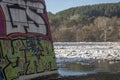 Unknown graffiti and ice melting in Neris river Royalty Free Stock Photo